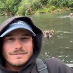 watch:-massive-brown-bear-comes-within-feet-of-fisherman-to-grab-salmon