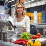 teenage-cashier-desperately-hoping-middle-aged-man-will-start-up-small-talk-with-her