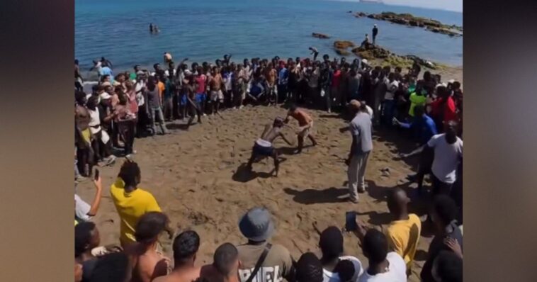 watch:-invaders-turn-ceuta-beach-into-a-slum-with-shacks-made-with-straw-and-cardboard,-hold-massive-‘fight-clubs’-by-the-water-(videos)