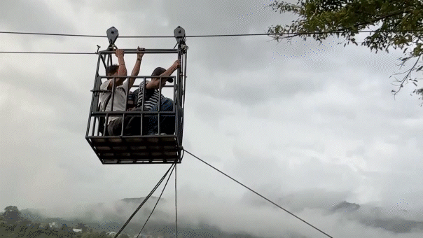 rescuers-use-ziplines-to-transport-trapped-citizens-after-devastating-nepal-floods-decimate-country’s-bridges