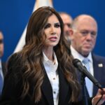 kristi-noem-offers-cringeworthy-take-on-markwayne-mullin’s-emergency-landing-in-coast-guard-plane