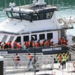 black-clad-protesters-in-balaclavas-march-in-dover-against-channel-migrant-crisis
