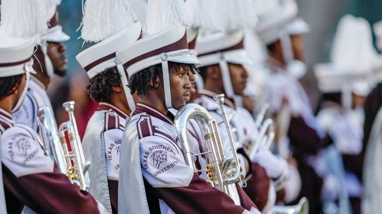 marching-band-tuba-player-unleashes-punches-on-man-at-college-football-game-without-missing-a-beat