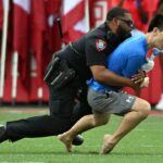 fan-runs-onto-field-at-houston-cougars-game,-gets-absolutely-trucked-by-police-officer