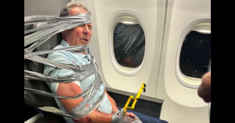 unhinged-airplane-passenger-duct-taped-to-seat-by-gun-shop-owner-in-viral-moment