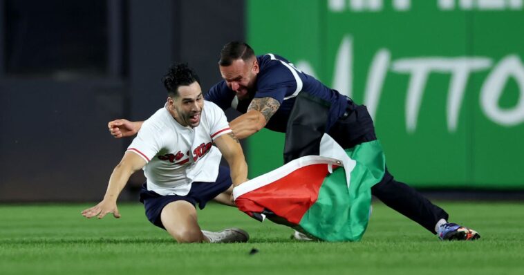 sick:-at-9:11-pm-on-25th-anniversary-of-9/11,-man-runs-on-field-at-yankee-stadium-with-palestinian-flag