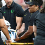 watch:-usc-player-smiles-on-sideline-after-illegal-hit-that-sent-oregon-qb-to-the-hospital