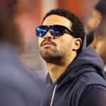 caleb-williams,-limited-by-a-hamstring-injury,-seen-casually-pacing-bears-sideline-during-national-anthem