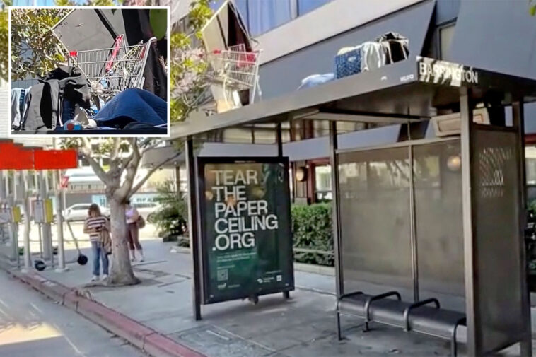 homeless-man-makes-a-camp,-complete-with-shopping-cart,-atop-a-bus-shelter-in-upscale-la-neighborhood
