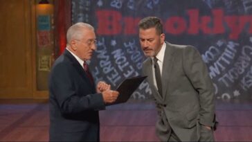 robert-de-niro-jokingly-prods-jimmy-kimmel-with-a-baseball-bat-while-posing-as-fcc-chair,-threatens-host