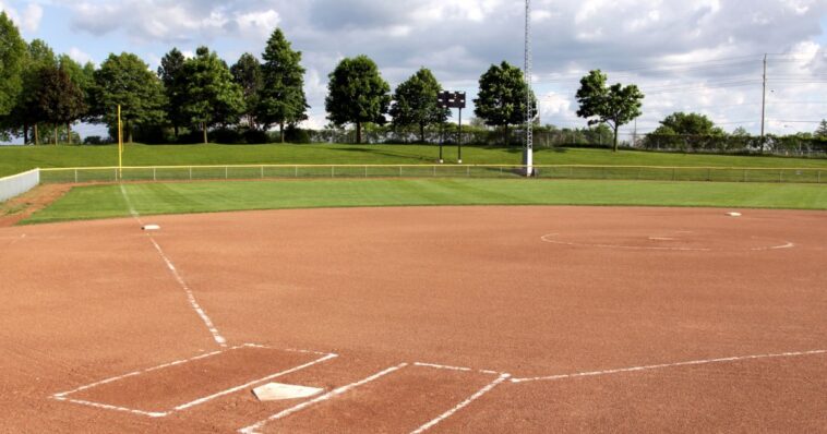 2-sisters,-both-adopted-to-separate-families,-meet-as-opposing-players-during-softball-game