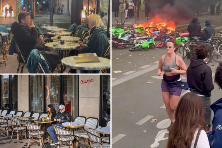 french-couple-casually-enjoy-a-smoke-and-a-drink,-jogger-runs-as-riot-fires-rage-around-them