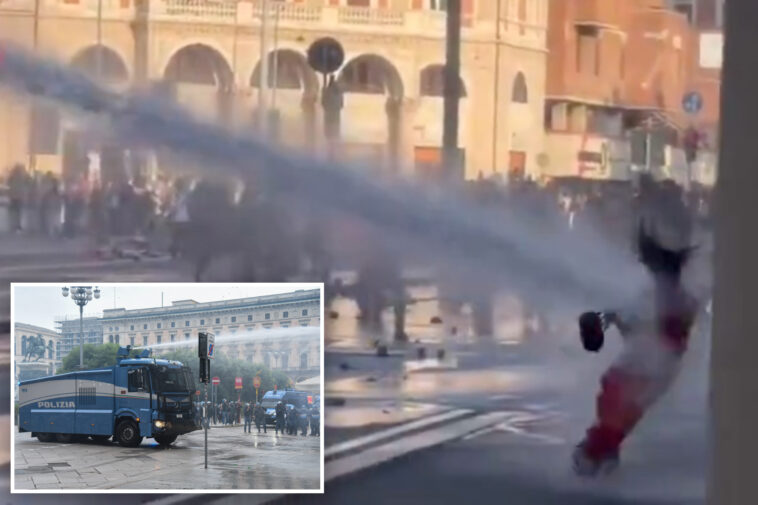 wild-moment-italian-cops-blast-young-protester-with-water-cannon-after-she-joined-far-left-rioters